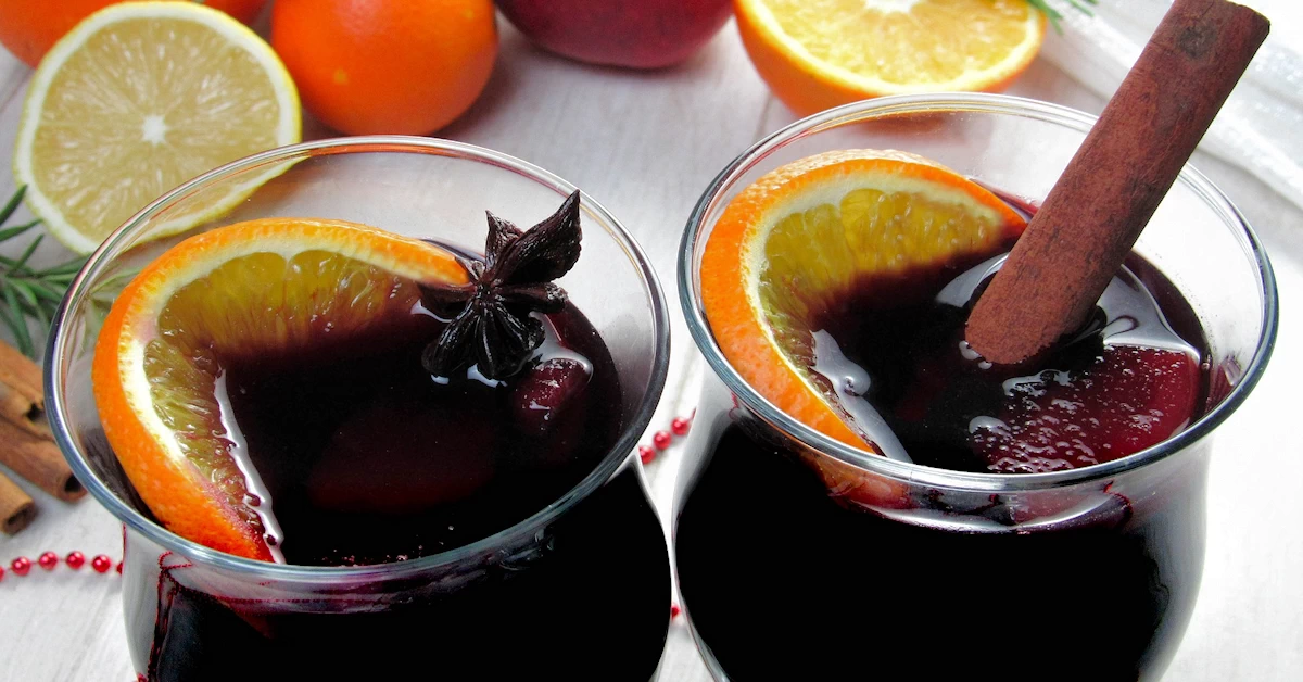 Cinnamon Mulled Wine: A Festive Blend of Red Wine, Sugar, Spices, and Oranges, Creating a Warm and Comforting Holiday Beverage.