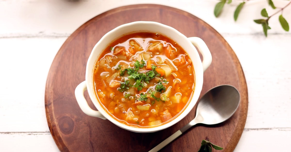 Savory Bliss in a Bowl: Hearty Bean Soup Enriched With a Medley of Vegetables, a Comforting Delight for the Senses.