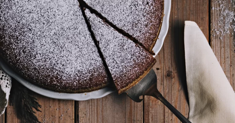 Decadent Red Wine Cake Topped With Powdered Sugar, a Delightful Treat for Any Occasion. Rich, Moist, and Irresistible.